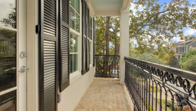 Second story balcony view of a Houston neighborhood. Black iron railing. 