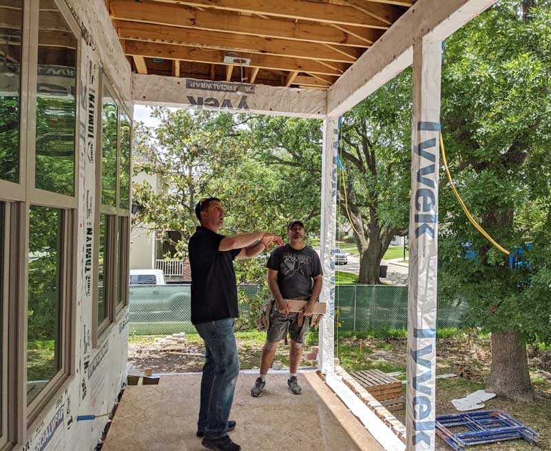 Ed Sabo reviewing architectural drawings new home construction