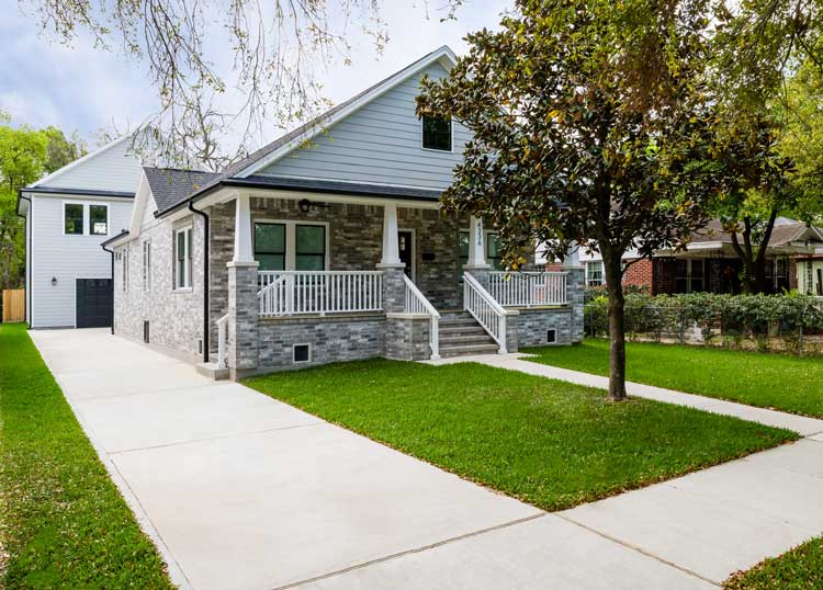 Drive way leading to a 2-car garage with an apartment on the second floor