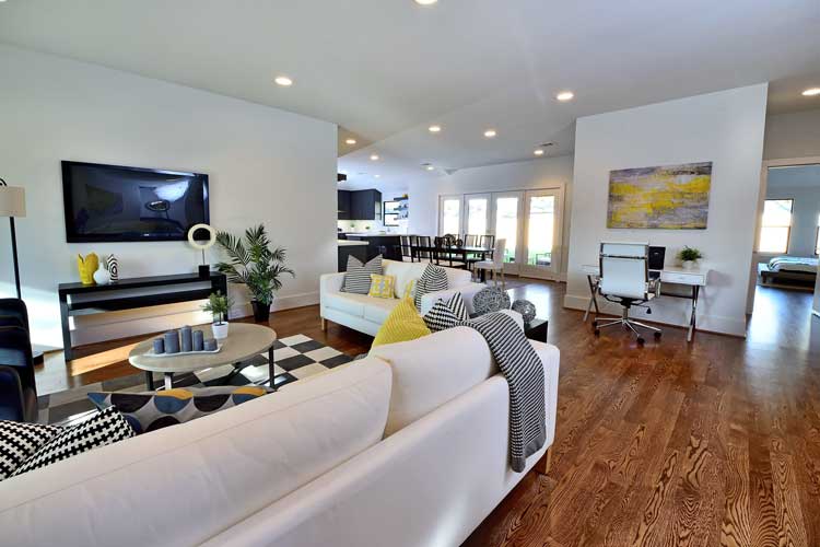 living room in remodeled home in houston texas with view of kitchen and french doors to patio