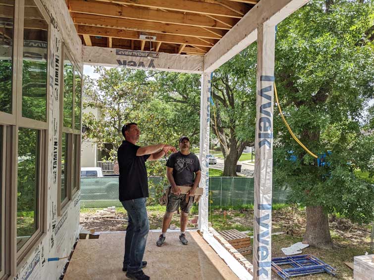 General contractor and custom home builder, Ed Sabo, inspecting porch structure