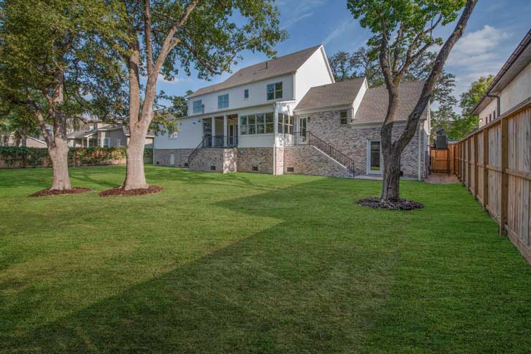 Two story custom home with large backyard and shade trees